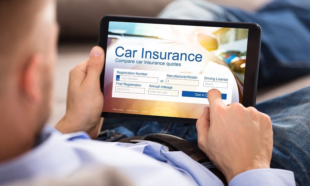 Illustration of a driver comparing auto insurance quote options on a tablet